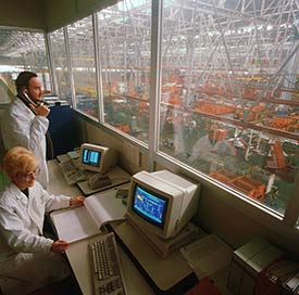 Image of two people reviewing an industrial production room.